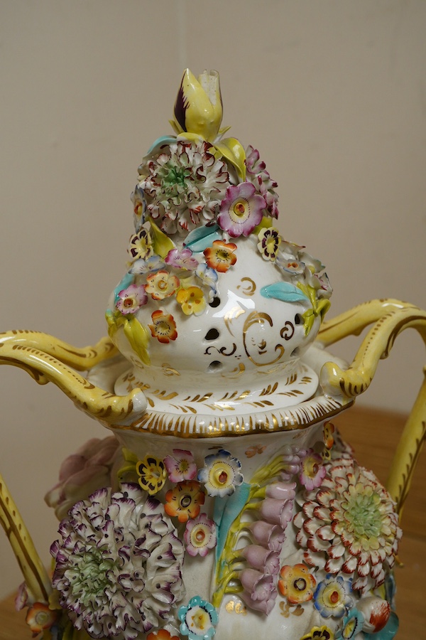 A pair of English porcelain floral encrusted vases and covers, c.1830, possibly Samuel Alcock, each painted with landscapes, 44cm high